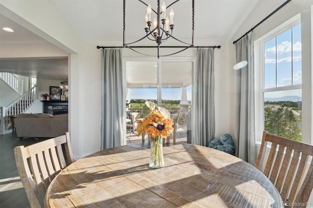 3741 Harvard Pl, Broomfield, CO 80023 - dining area with a chandelier, vaulted ceiling, and stairway