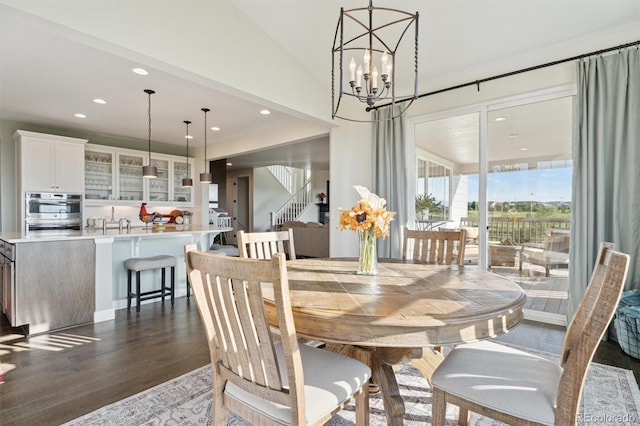 3741 Harvard Pl, Broomfield, CO 80023 - dining room featuring a chandelier, recessed lighting, dark wood finished floors, and stairway