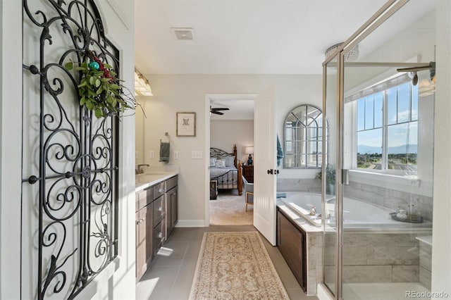 3741 Harvard Pl, Broomfield, CO 80023 - ensuite bathroom featuring vanity, a garden tub, tile patterned floors, a ceiling fan, and a stall shower