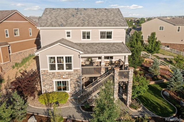 3741 Harvard Pl, Broomfield, CO 80023 - rear view of house featuring stone siding, a shingled roof, a wooden deck, and stairway
