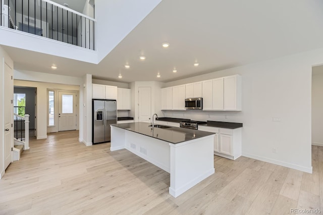 39857 Floyd St, Elizabeth, CO 80107 - kitchen with appliances with stainless steel finishes, dark countertops, recessed lighting, light wood-style flooring, and white cabinetry