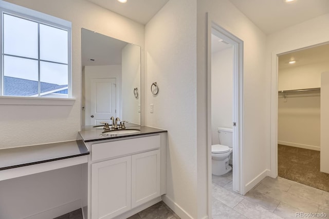39857 Floyd St, Elizabeth, CO 80107 - bathroom featuring vanity, a walk in closet, and recessed lighting