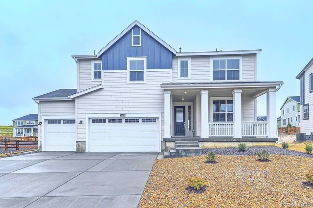 39857 Floyd St, Elizabeth, CO 80107 - view of front facade featuring covered porch, board and batten siding, driveway, and an attached garage