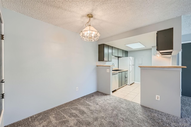 kitchen featuring light carpet, a textured ceiling, and green cabinets