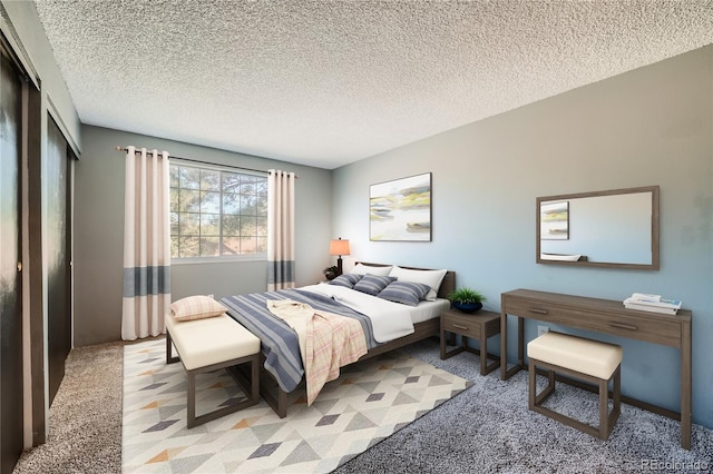 carpeted bedroom featuring a textured ceiling