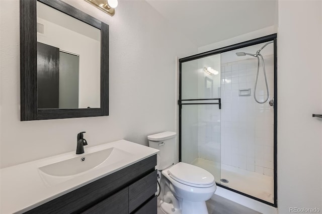 bathroom with walk in shower, toilet, and vanity