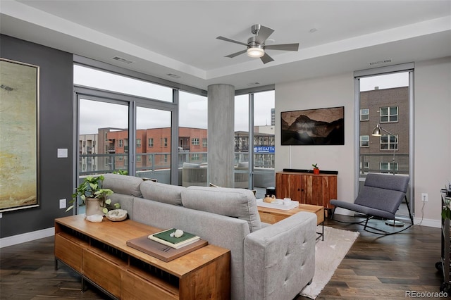 living room featuring visible vents, plenty of natural light, and dark wood-style floors