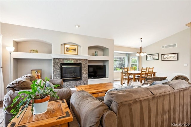 19113 W 60th Ln, Golden, CO 80403 - living area with a chandelier, a tile fireplace, lofted ceiling, and built in features
