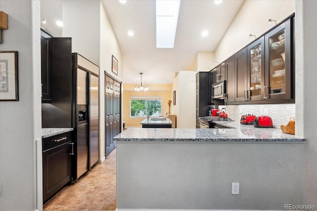 19113 W 60th Ln, Golden, CO 80403 - kitchen featuring stainless steel appliances, light stone countertops, glass insert cabinets, and recessed lighting