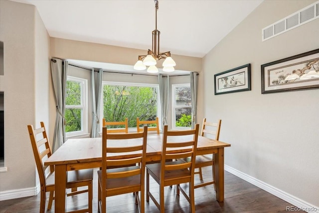 19113 W 60th Ln, Golden, CO 80403 - dining space featuring a chandelier, dark wood-style floors, and vaulted ceiling