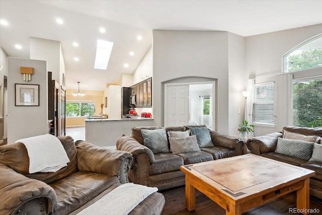 19113 W 60th Ln, Golden, CO 80403 - living area featuring a skylight, high vaulted ceiling, a chandelier, recessed lighting, and dark wood-style flooring