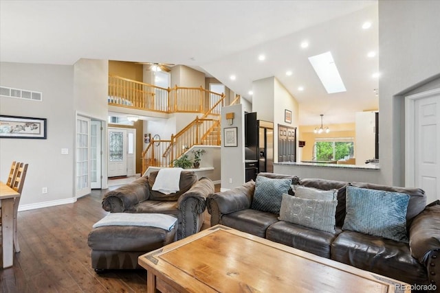 19113 W 60th Ln, Golden, CO 80403 - living room featuring stairway, high vaulted ceiling, dark wood finished floors, a skylight, and recessed lighting