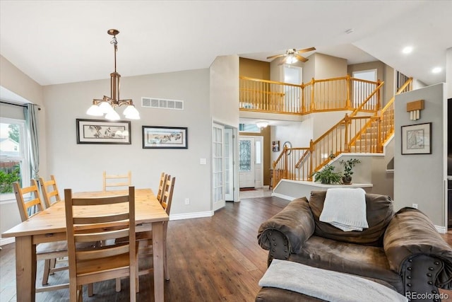 19113 W 60th Ln, Golden, CO 80403 - dining room with stairs, hardwood / wood-style flooring, a chandelier, a ceiling fan, and high vaulted ceiling