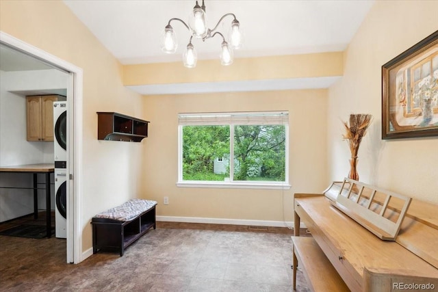19113 W 60th Ln, Golden, CO 80403 - interior space with stacked washing machine and dryer and a chandelier