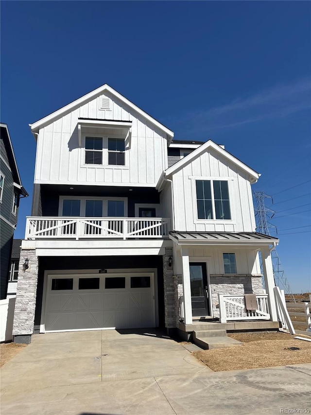 view of front facade with driveway, a standing seam roof, covered porch, board and batten siding, and metal roof