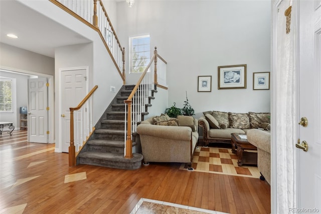 17391 E Weaver Ave, Aurora, CO 80016 - living area with wood-type flooring, stairway, a high ceiling, and recessed lighting