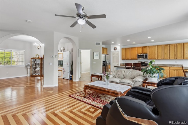 17391 E Weaver Ave, Aurora, CO 80016 - living room with arched walkways, a ceiling fan, recessed lighting, baseboards, and a chandelier