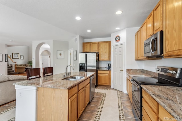 17391 E Weaver Ave, Aurora, CO 80016 - kitchen featuring stainless steel appliances, a sink, open floor plan, light tile patterned floors, and recessed lighting
