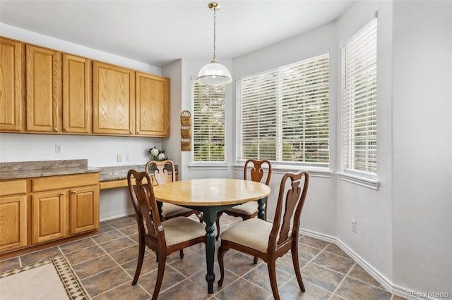 17391 E Weaver Ave, Aurora, CO 80016 - dining space with dark tile patterned floors and baseboards
