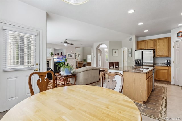 17391 E Weaver Ave, Aurora, CO 80016 - dining space featuring ceiling fan, arched walkways, plenty of natural light, recessed lighting, and light tile patterned floors