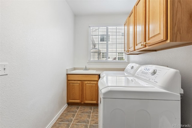 17391 E Weaver Ave, Aurora, CO 80016 - washroom featuring washing machine and clothes dryer, cabinet space, a textured wall, and baseboards