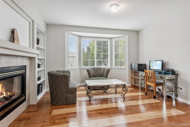 17391 E Weaver Ave, Aurora, CO 80016 - office space featuring hardwood / wood-style floors, a tile fireplace, and healthy amount of natural light