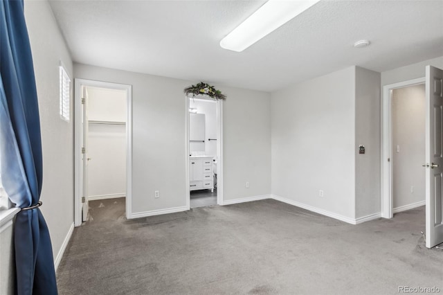 17391 E Weaver Ave, Aurora, CO 80016 - unfurnished bedroom with carpet, a walk in closet, and baseboards
