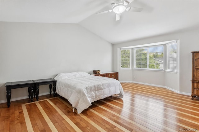 17391 E Weaver Ave, Aurora, CO 80016 - bedroom with light wood finished floors, vaulted ceiling, baseboards, and a ceiling fan