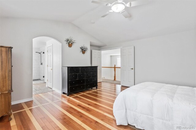 17391 E Weaver Ave, Aurora, CO 80016 - bedroom featuring arched walkways, hardwood / wood-style flooring, vaulted ceiling, a ceiling fan, and ensuite bath