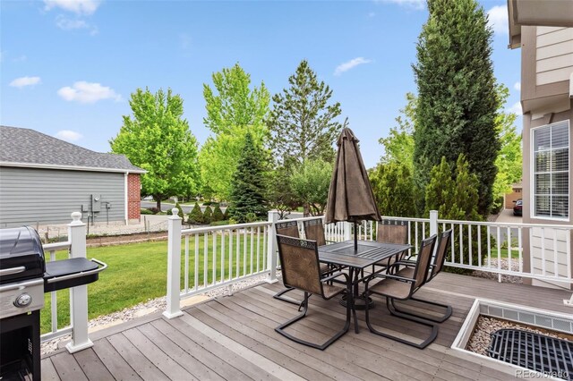 17391 E Weaver Ave, Aurora, CO 80016 - wooden terrace with outdoor dining area, a lawn, and area for grilling