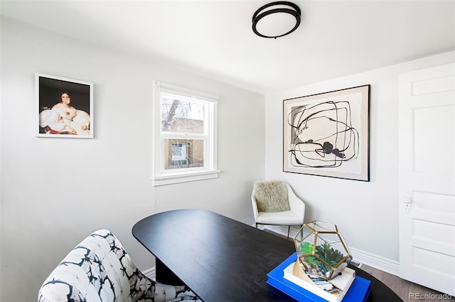 home office with baseboards and wood finished floors