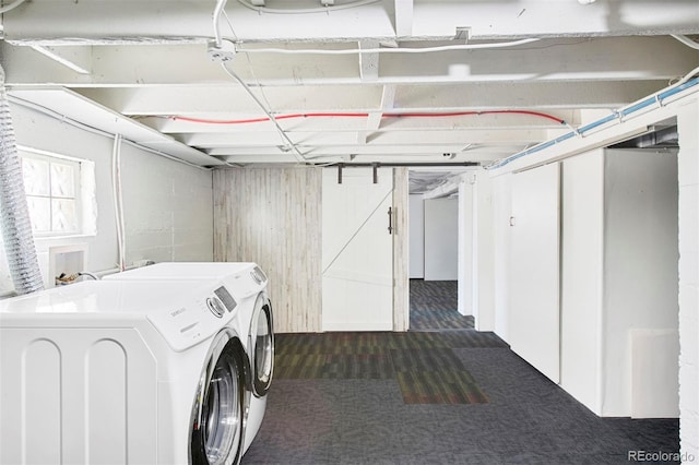 below grade area featuring separate washer and dryer and dark carpet