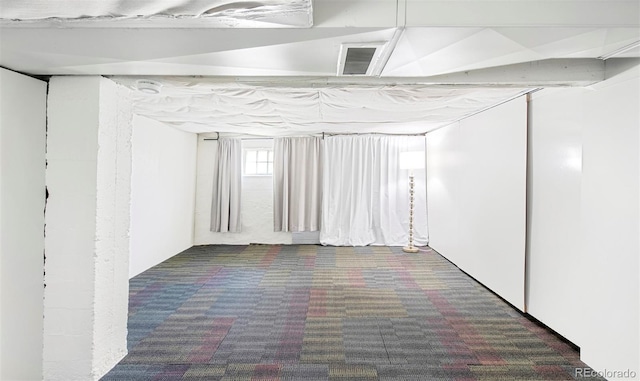 basement with visible vents and carpet