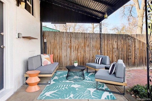 view of patio featuring fence and an outdoor living space