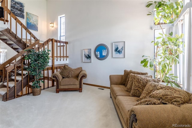 750 S Dearborn Ct, Aurora, CO 80012 - living area with carpet floors, stairway, and a high ceiling