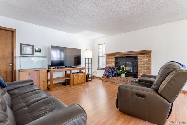 750 S Dearborn Ct, Aurora, CO 80012 - living room with light wood-style flooring, a textured ceiling, and a fireplace