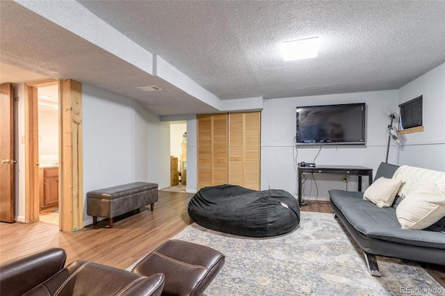 750 S Dearborn Ct, Aurora, CO 80012 - living area featuring a textured ceiling and light wood finished floors