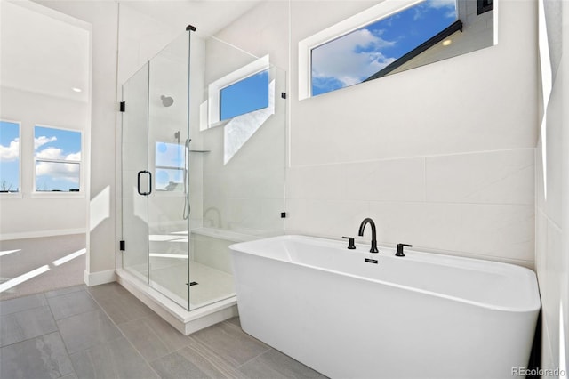 bathroom with tile patterned floors and plus walk in shower