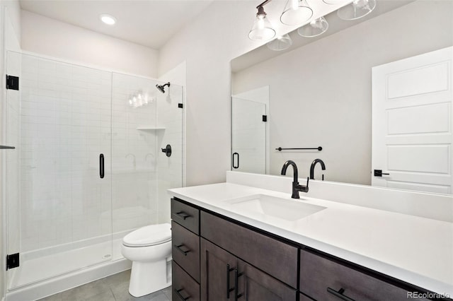 bathroom featuring toilet, vanity, tile patterned flooring, and walk in shower