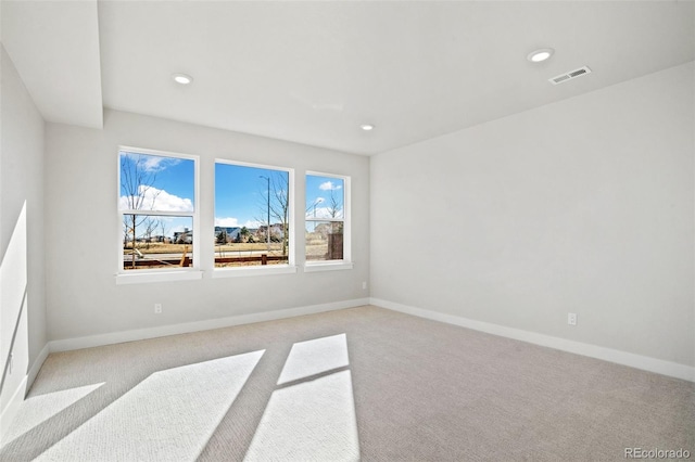 unfurnished room featuring light colored carpet