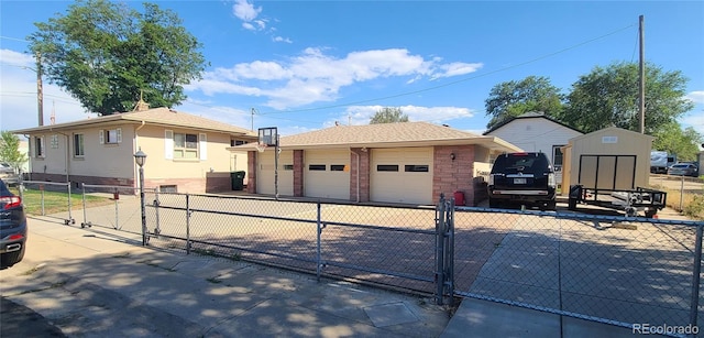 5423 Pecos St, Denver, CO 80221 - view of front facade with an outdoor structure, a gate, brick siding, and a detached garage