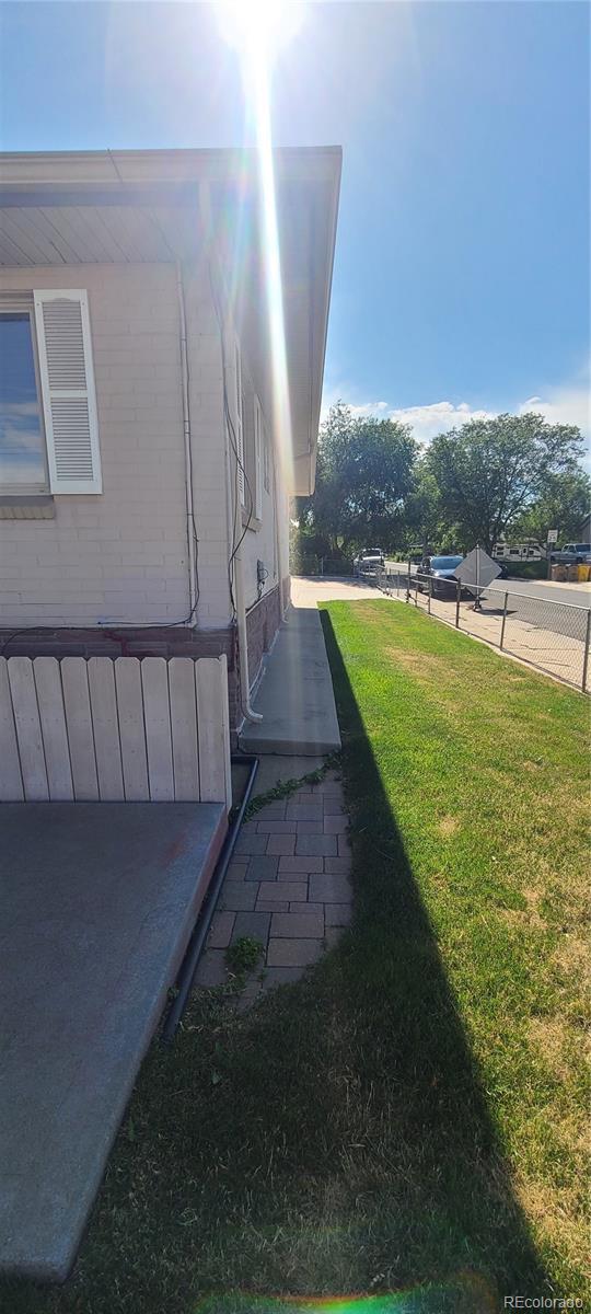 5423 Pecos St, Denver, CO 80221 - view of side of home with a lawn
