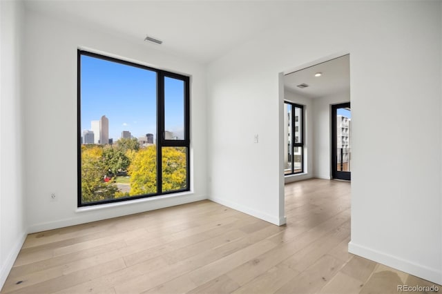 spare room with light hardwood / wood-style floors