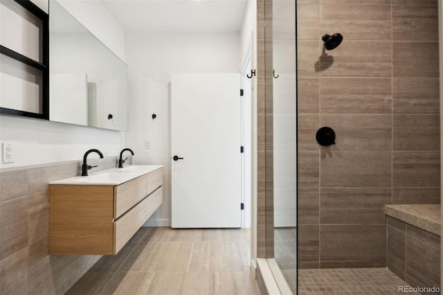 bathroom featuring vanity and tiled shower