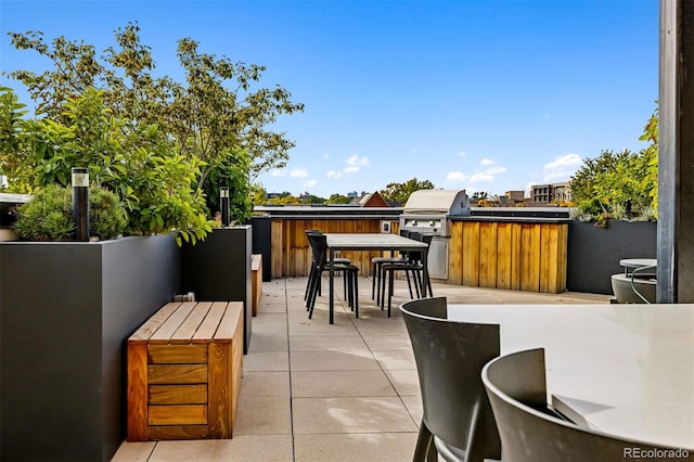 view of patio featuring an outdoor bar, exterior kitchen, and area for grilling