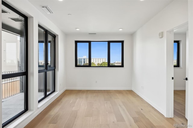 unfurnished room with light hardwood / wood-style floors