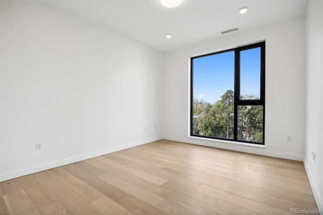 unfurnished room with light wood-type flooring