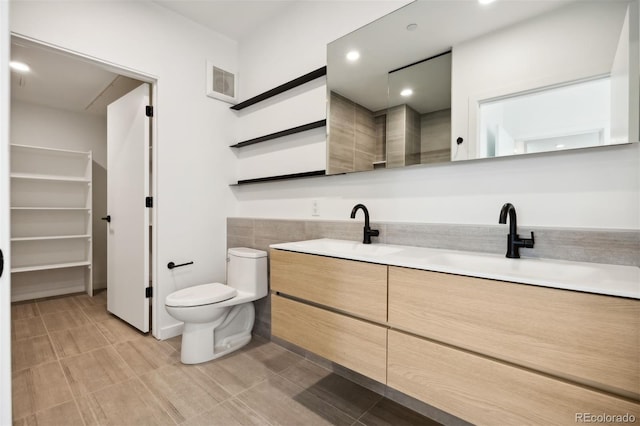 bathroom with toilet and vanity