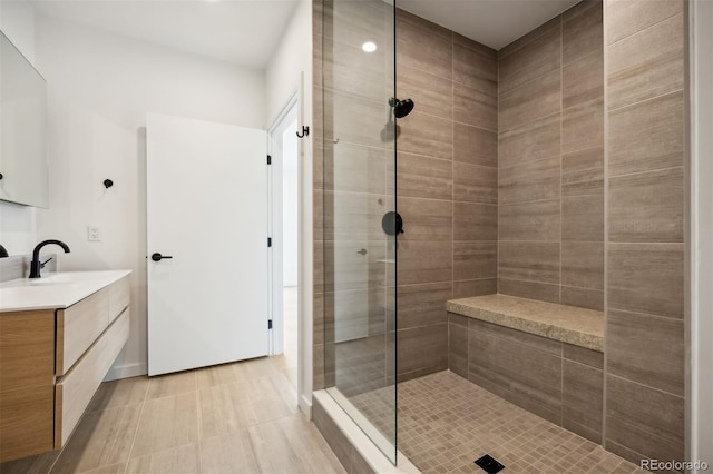 bathroom with vanity and tiled shower