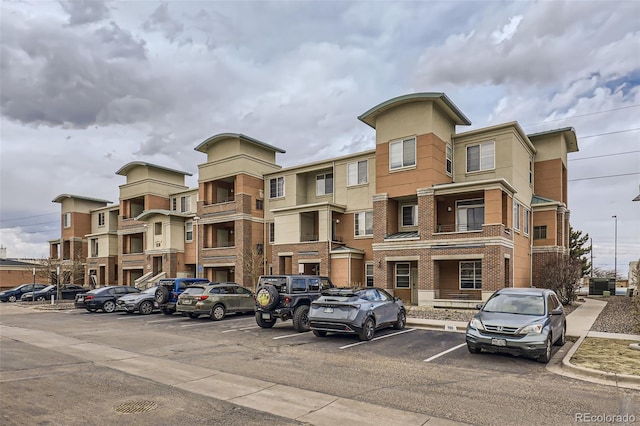 view of building exterior with uncovered parking